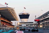 George Russell, Mercedes, pursues Lando Norris, McLaren, Yas Marina, 2023